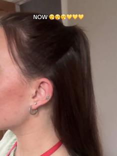 Woman's dark brown hair in a ponytail.