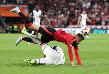 Manchester United's Noussair Mazraoui tackling a Tottenham Hotspur player.