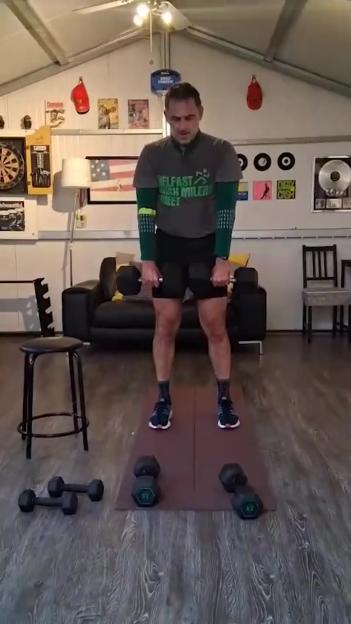 Ronnie O'Sullivan exercising with dumbbells.