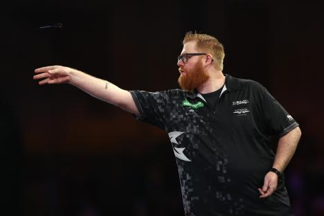 Matt Campbell of Canada throwing a dart.
