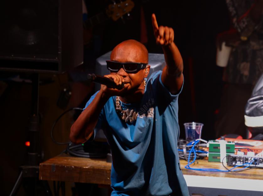 Slim Jxmmi performing onstage at a concert.