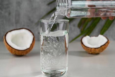 Pouring coconut water into a glass.
