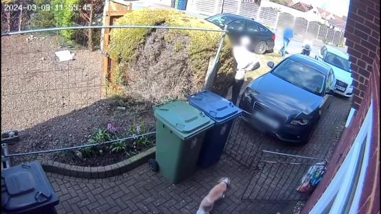 CCTV image of a car driving towards a woman.