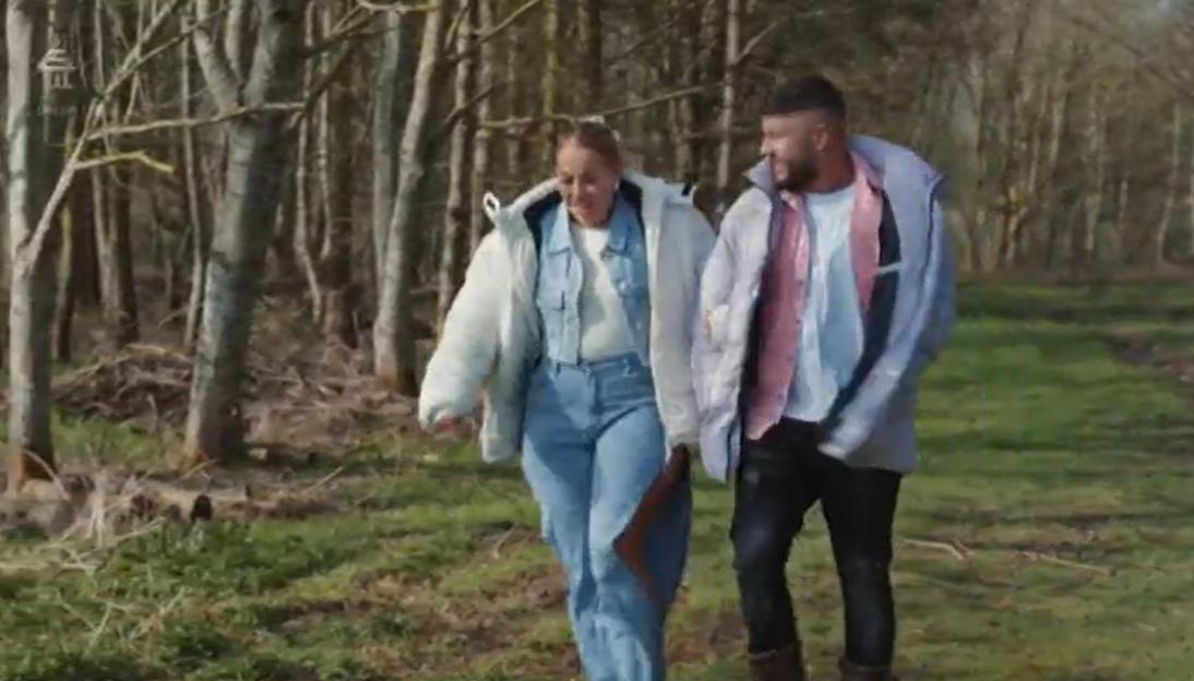 Polly and her husband walking outdoors.