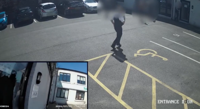 Man walking in a parking lot with a smaller, inset video showing a building.
