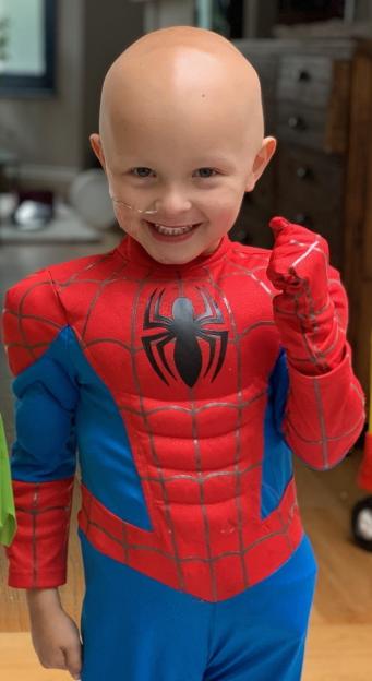 A younger Gaspard Ronsseray dressed as Spider-Man, smiling and holding a fist.