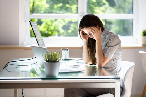 Stressed businesswoman at her desk.