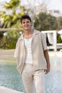 Man smiling by a pool.