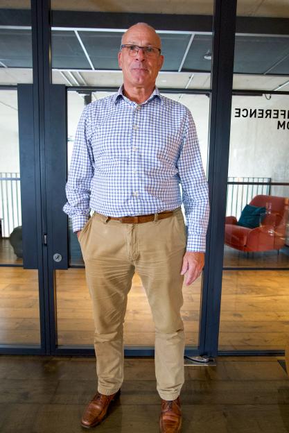 Stephen Lear standing in a conference room.