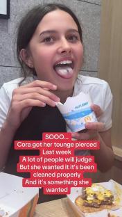 Teenage girl with a new tongue piercing.