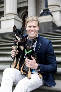 Dr. Chris Brown holding two dogs.