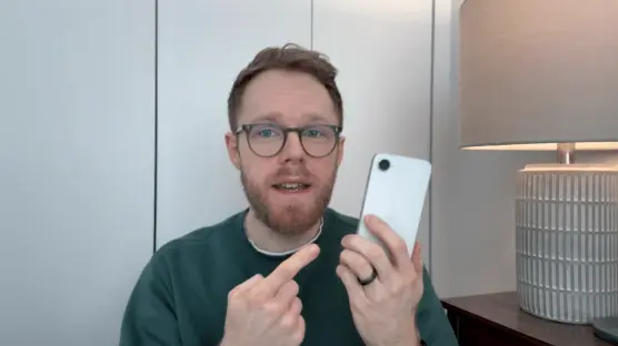 Man holding up a smartphone and gesturing.