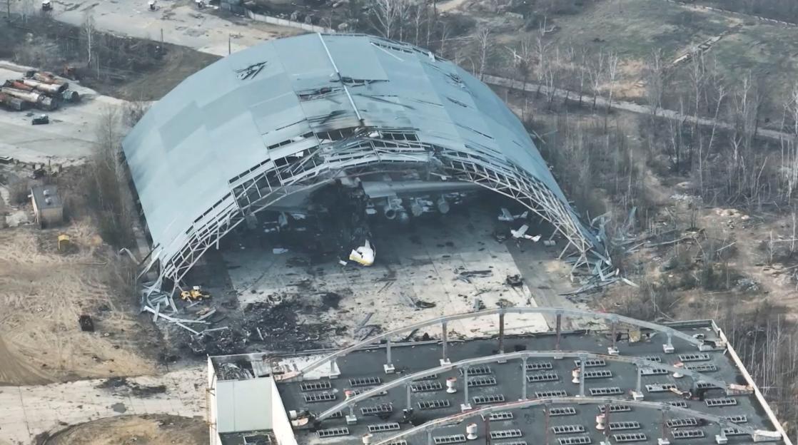Damaged aircraft inside a destroyed hangar at Antonov International Airport.