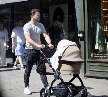 Mark Wright pushing a baby stroller.