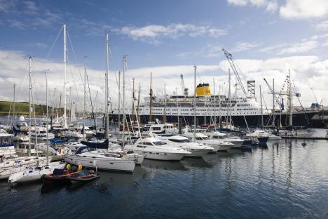Harbor with many sailboats and a large ship.