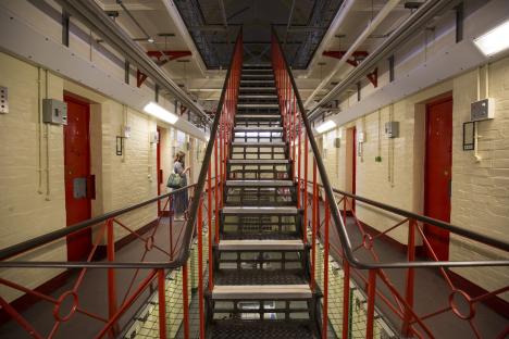 Interior view of Reading Prison, showing a metal staircase and prison cells.