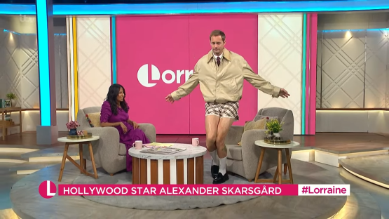 Alexander Skarsgård in shorts and a jacket on a talk show.