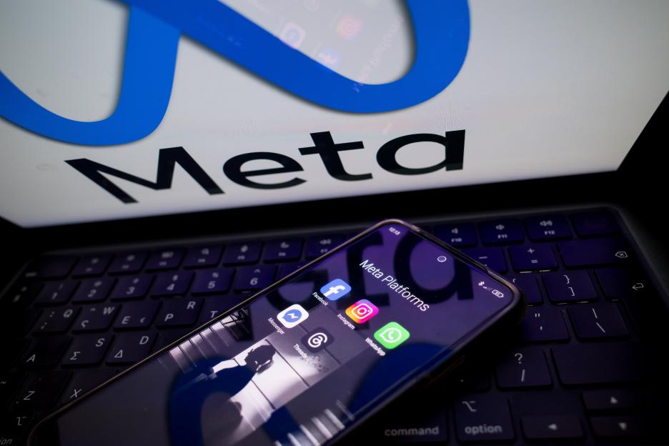 Illustration of a smartphone displaying Meta Platforms apps on a laptop.