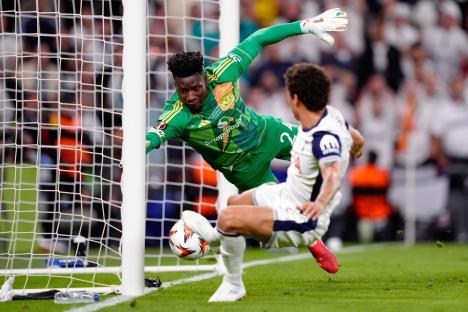 Andre Onana of Manchester United diving to stop a goal.