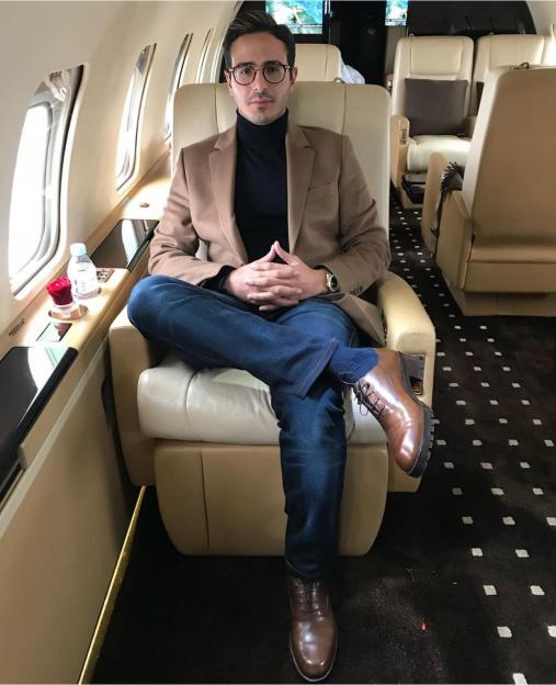 Simon Leviev sitting on a private jet.