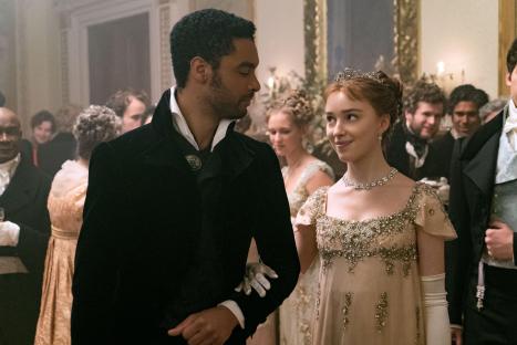 A man and woman in Regency-era attire at a ball.