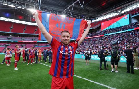 Josh Barrett of Aldershot Town celebrating victory at Wembley Stadium.