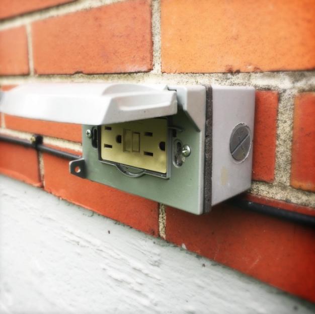 waterproof plug on brick wall