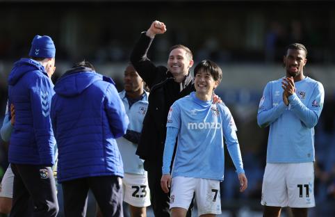 Frank Lampard, Coventry City manager, celebrates a victory with players.
