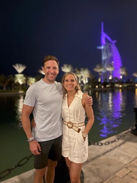 Couple posing in Dubai with Burj Al Arab in the background.