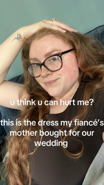 Woman wearing glasses and a dress, with text overlay saying her fiancé's mother bought the dress for their wedding.