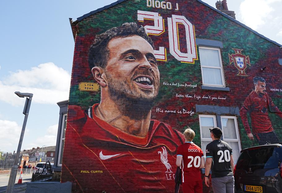Liverpool fans visiting a Diogo Jota mural.
