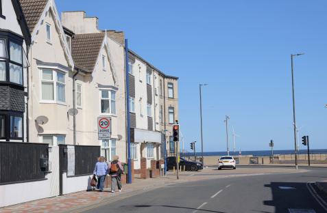 Street scene in Redcar, Cleveland, showing houses, a 20 mph zone sign, and the sea in the distance.