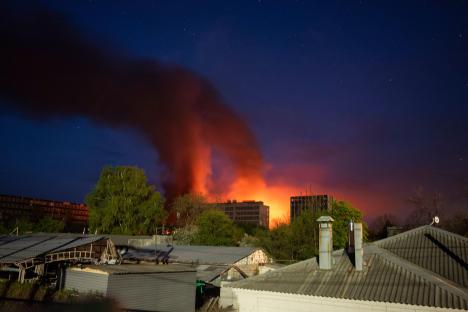 A factory burning in Kharkiv, Ukraine, after a Russian strike.