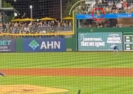 Baseball pitcher pitching in a stadium.
