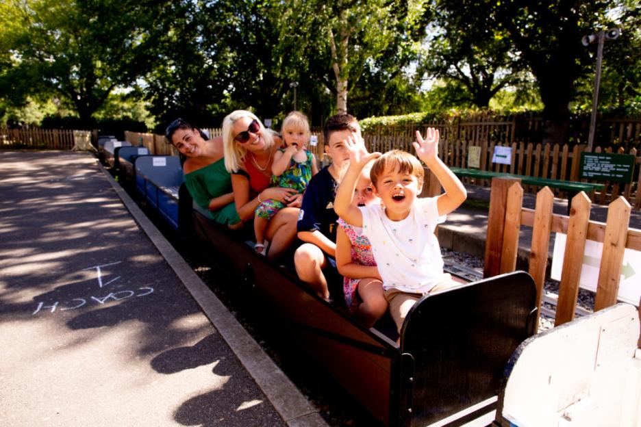 Family riding on a park train.
