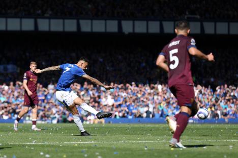 Dwight McNeil of Everton scoring a goal.