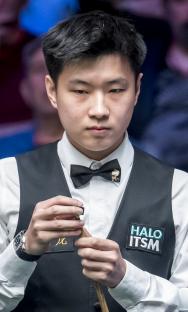 Zhao Xintong playing snooker.