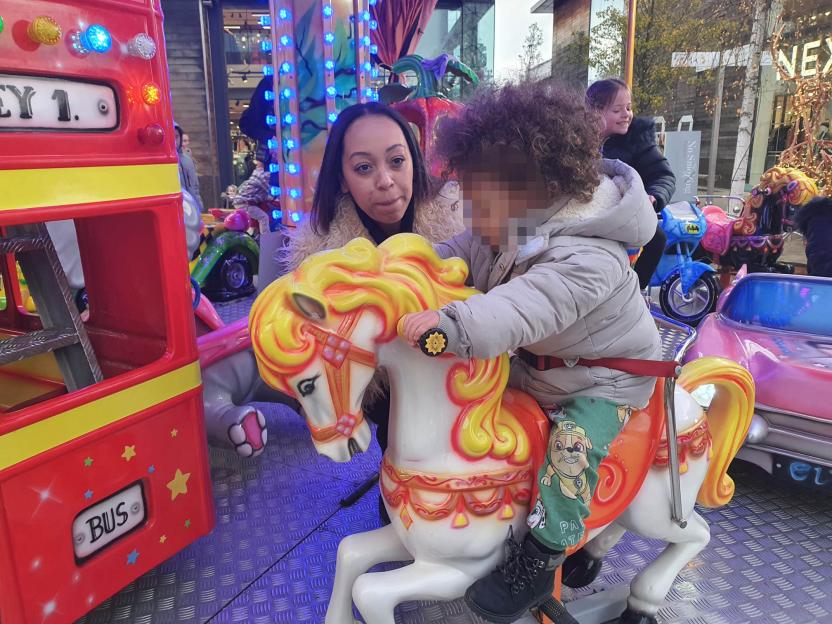 Zara, the dominatrix, on a fairground ride with a child.