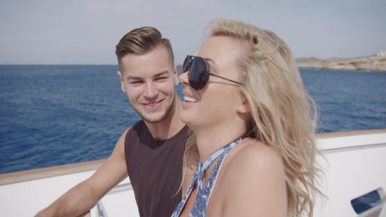 Couple smiling on a boat.