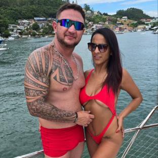 A man and woman in red swimwear on a boat.