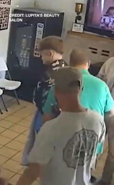 Surveillance image of a group of people inside a business.