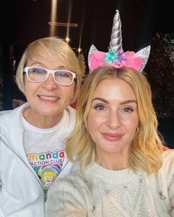 Photo of two women, one wearing a unicorn headband.