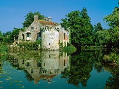 Scotney Old Castle reflected in a pond.