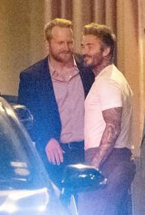 David Beckham and a man in a suit at a restaurant.