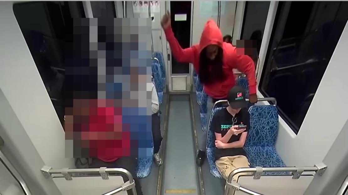 Security footage of a person assaulting another on a public transit vehicle.
