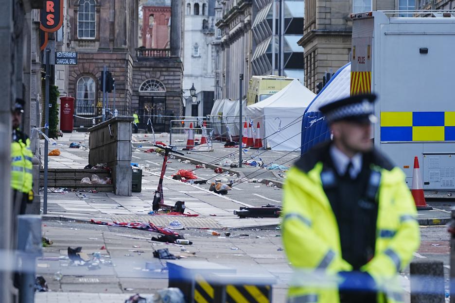 Police tents and debris at a Liverpool city center scene.