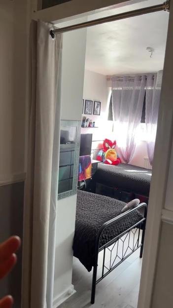Children's bedroom with beds and curtains instead of doors.