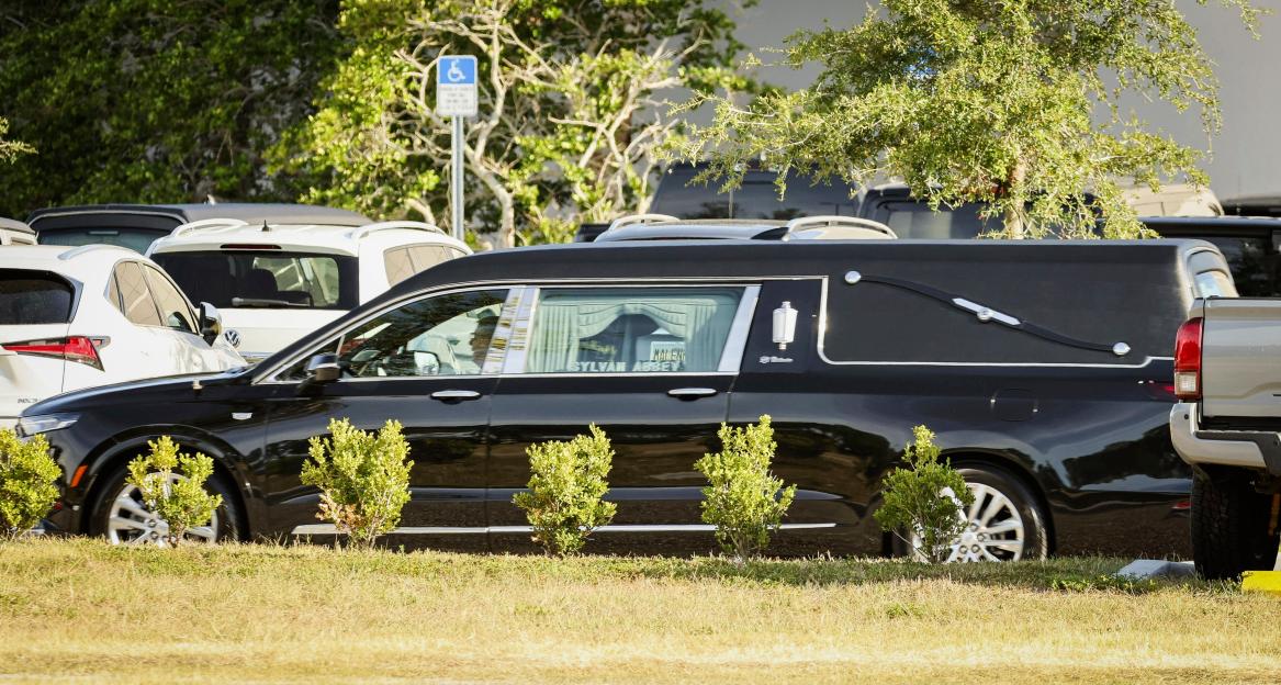 Hearse leaving a memorial service.