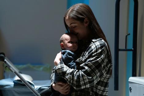 A woman holding a baby.