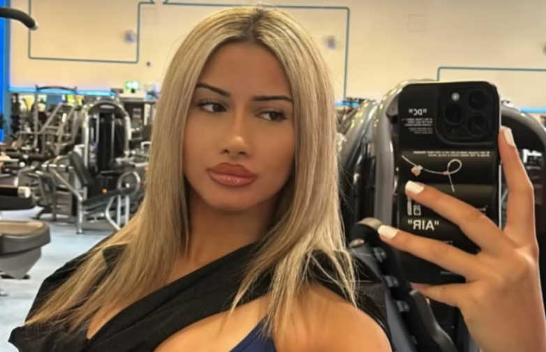 Woman taking a selfie in a gym.